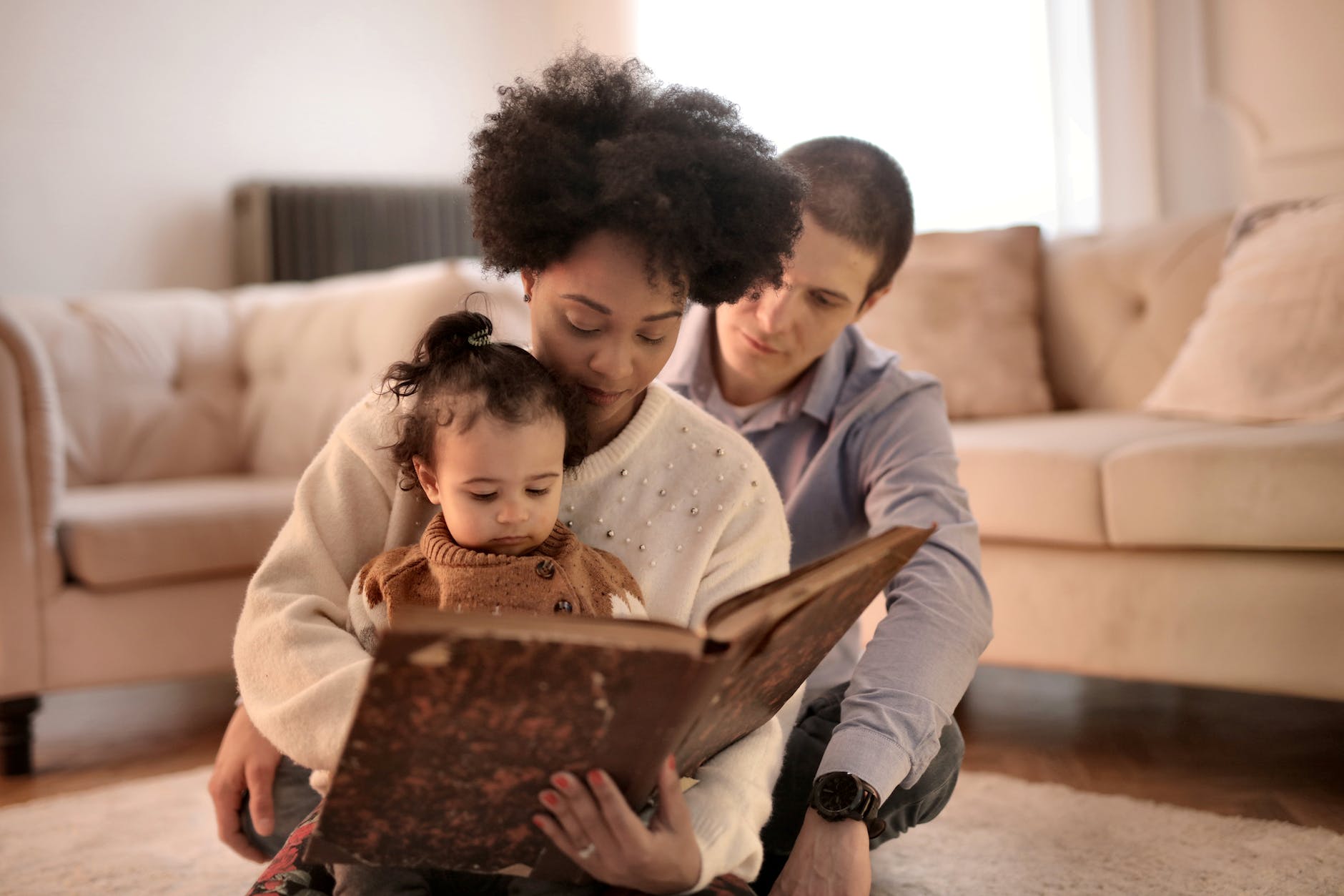 photo of woman holding brown book with her child in Fill in the Blank Questions for Kids